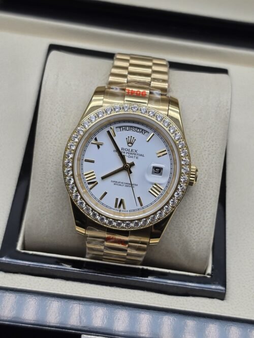 Rolex — esfera blanca con números romanos y bisel brillante y brazalete dorado · 41 mm