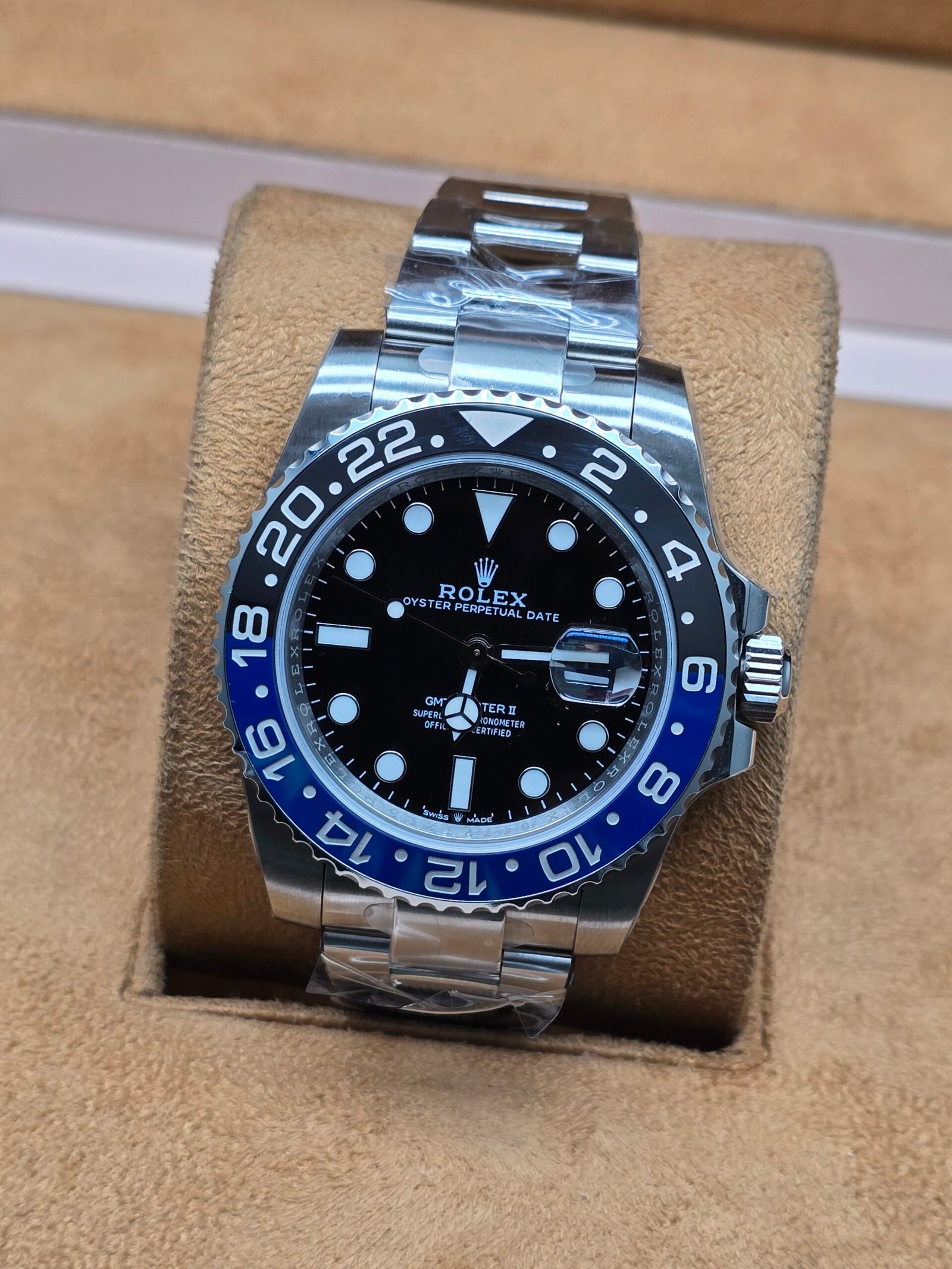 Rolex — bisel negro y azul · brazalete plateado