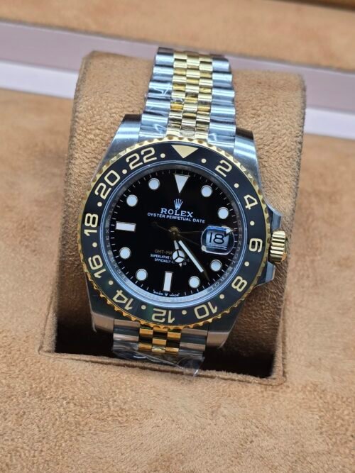 Rolex — bisel negro y dorado · brazalete bicolor