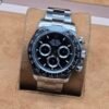 Rolex — esfera negra con tres subesferas · brazalete plateado