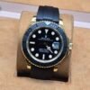 Rolex — esfera negra · caja dorada y correa negra