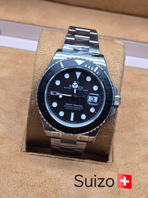 Rolex — esfera negra y bisel oscuro · brazalete plateado