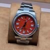 Rolex — esfera naranja y brazalete plateado
