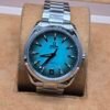 Omega — esfera turquesa y brazalete plateado
