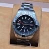 Breitling — esfera negra y brazalete plateado