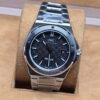 IWC — esfera negra texturizada y brazalete plateado