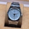 Tissot — esfera clara y brazalete plateado