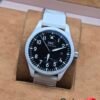 IWC — esfera negra y correa blanca