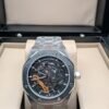 Audemars Piguet — esfera esqueleto con detalles naranjas y brazalete de acero