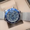 Breitling — esfera azul estampada, bisel azul y brazalete de malla de acero