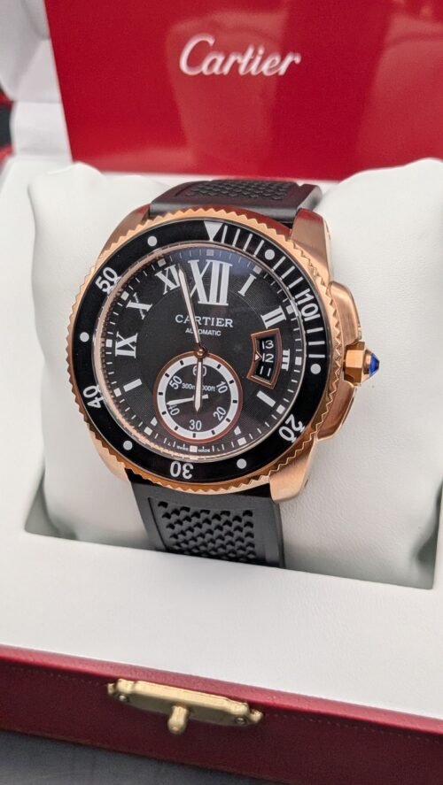 Cartier — esfera negra con números romanos, bisel negro, caja oro rosa y correa de caucho negra