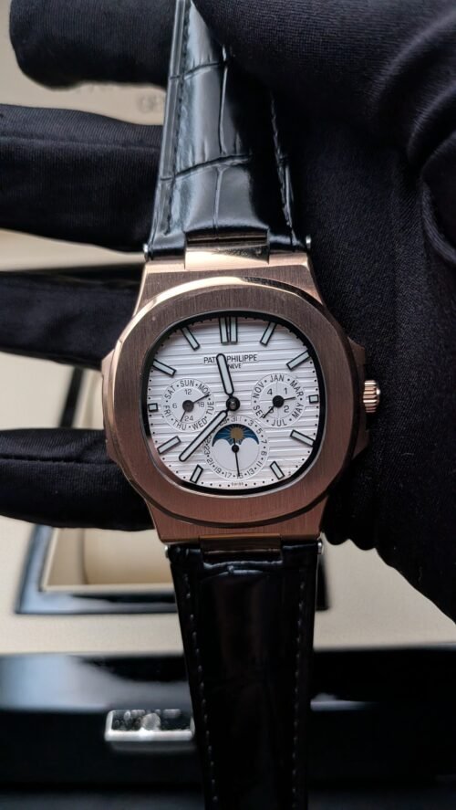 Patek Philippe — esfera blanca con fases lunares, caja oro rosa y correa de cuero negra