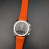 Patek Philippe — cronógrafo con esfera negra y detalles naranjas, correa de caucho naranja