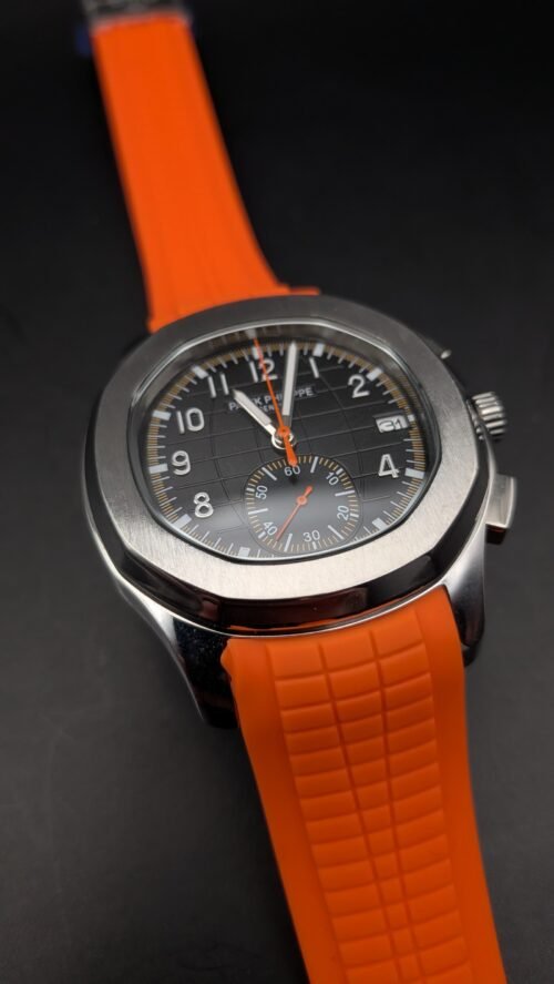Patek Philippe — cronógrafo con esfera negra y detalles naranjas, correa de caucho naranja