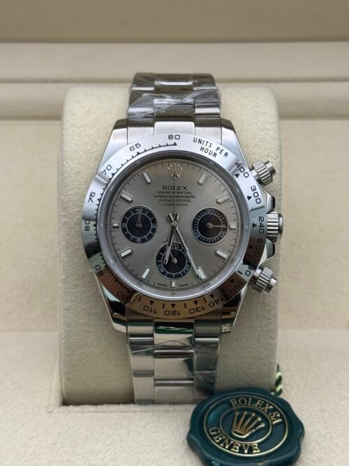 Rolex — cronógrafo con esfera gris y subesferas negras, brazalete de acero