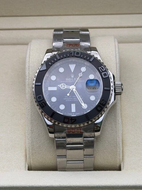 Rolex — esfera gris, bisel negro y brazalete de acero