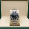 Rolex — esfera negra con doble huso horario, bisel negro y brazalete de acero