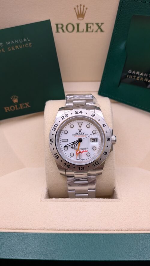 Rolex — esfera blanca con aguja GMT naranja y brazalete de acero