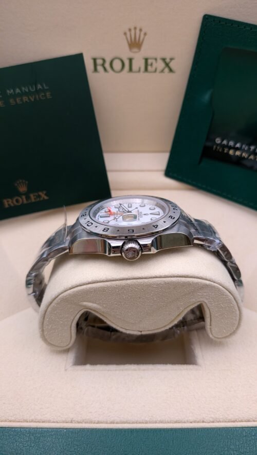 Rolex — esfera blanca con aguja GMT naranja y brazalete de acero