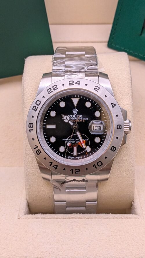 Rolex — esfera negra con aguja GMT naranja y brazalete de acero