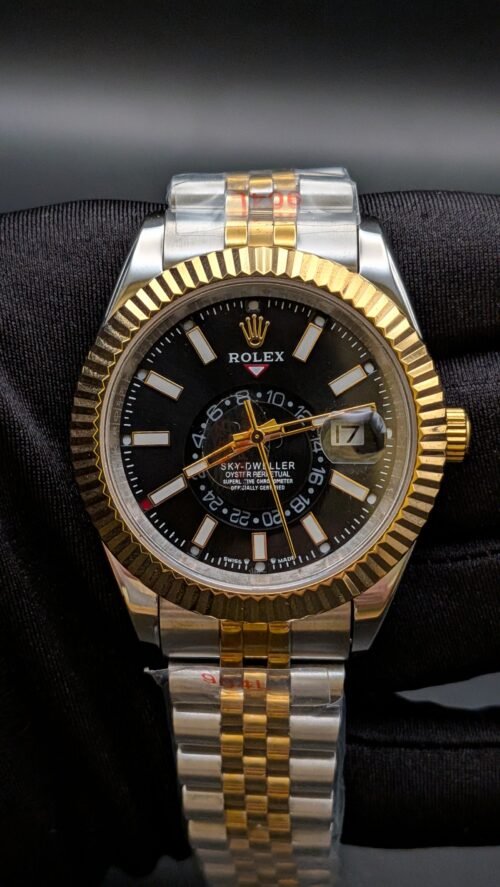 Rolex — esfera negra con calendario anual, bisel dorado estriado y brazalete jubilee bicolor