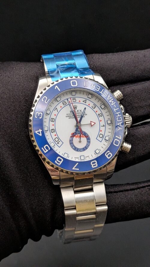 Rolex — cronógrafo regata con esfera blanca, bisel azul y brazalete de acero