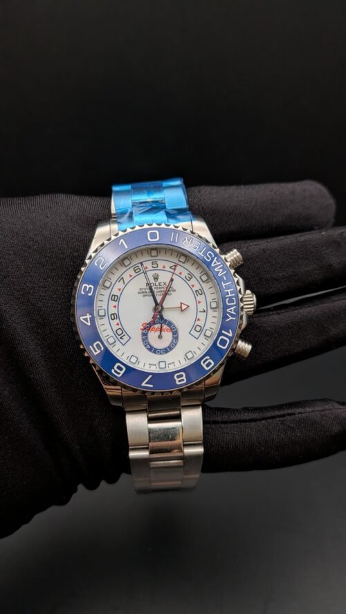 Rolex — cronógrafo regata con esfera blanca, bisel azul y brazalete de acero