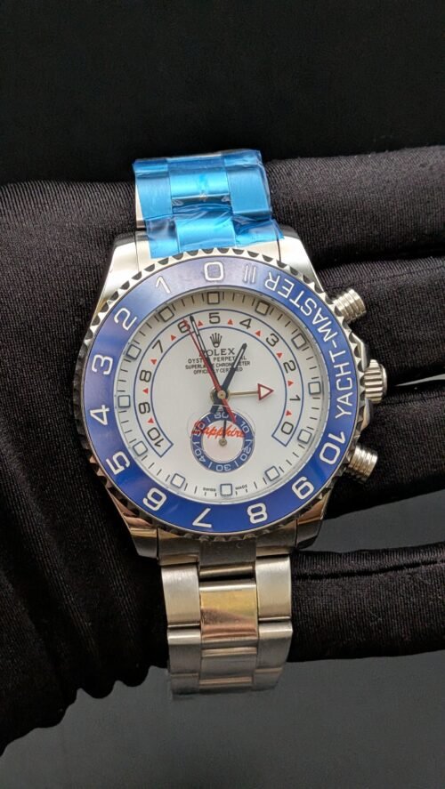 Rolex — cronógrafo regata con esfera blanca, bisel azul y brazalete de acero