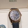 Rolex — esfera negra con calendario anual, caja dorada y correa de caucho negra
