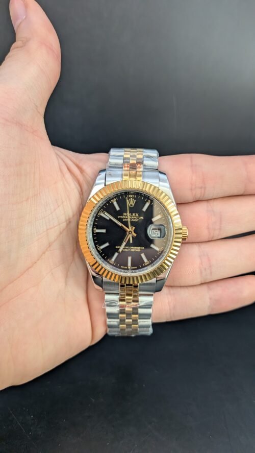 Rolex — esfera negra, bisel dorado estriado y brazalete jubilee bicolor