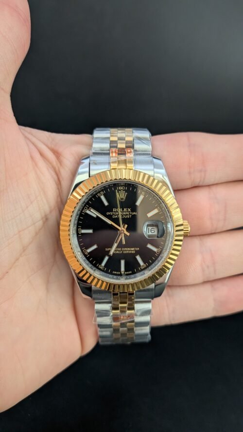 Rolex — esfera negra, bisel dorado estriado y brazalete jubilee bicolor