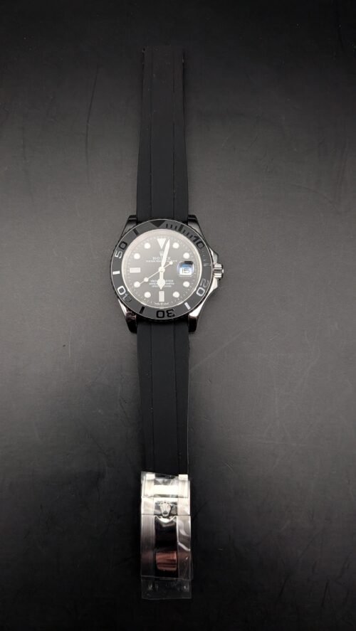 Rolex — esfera negra, bisel gris, caja de acero y correa de caucho negra
