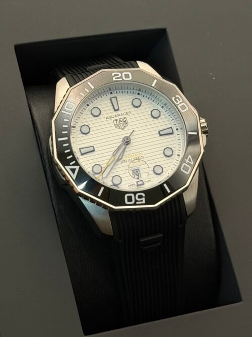 TAG Heuer — esfera blanca texturizada, bisel negro y correa de caucho negra