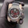 Tissot — cronógrafo con esfera de carbono y detalles rojos, caja de acero y correa negra