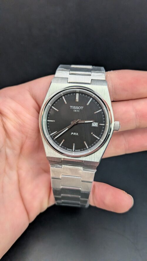 Tissot — esfera negra y brazalete de acero