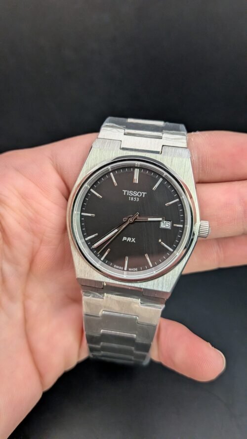 Tissot — esfera negra y brazalete de acero