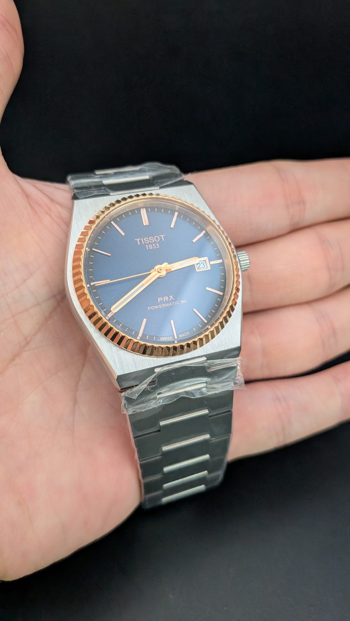 Tissot — esfera azul, bisel oro rosa estriado y brazalete de acero