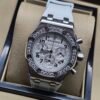 Audemars Piguet — cronógrafo con esfera blanca y números negros, bisel con brillantes y correa gris clara