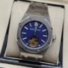 Audemars Piguet — esfera azul con tourbillon a la vista y brazalete de acero