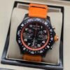 Breitling — cronógrafo negro con aro naranja y correa naranja
