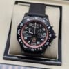Breitling — cronógrafo negro con aro rosado y correa negra