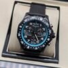Breitling — cronógrafo negro con aro turquesa y correa negra
