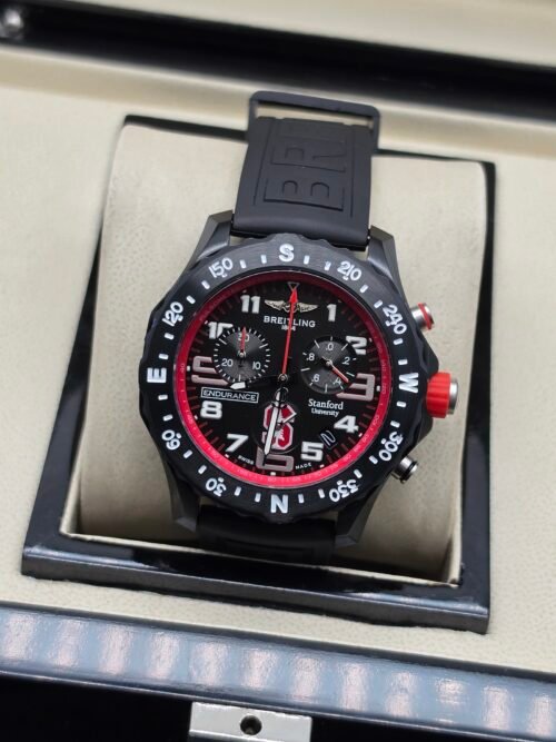 Breitling — cronógrafo negro con aro rojo y correa negra
