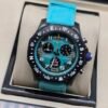 Breitling — cronógrafo con esfera turquesa, caja negra y correa turquesa