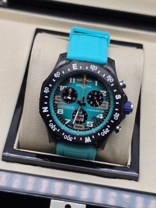 Breitling — cronógrafo con esfera turquesa, caja negra y correa turquesa