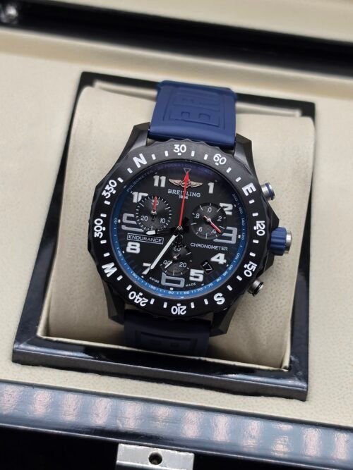 Breitling — cronógrafo negro con aro azul y correa azul oscura