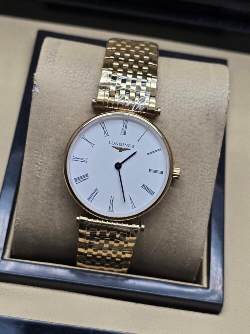 Longines — esfera blanca con números romanos, caja dorada y brazalete dorado
