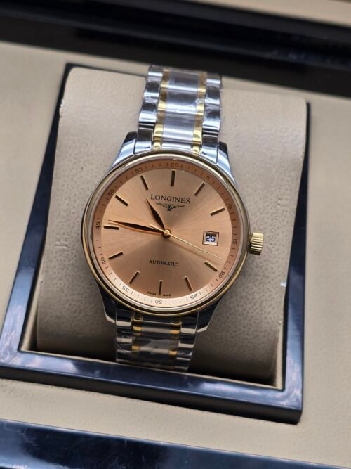 Longines — esfera salmón con fecha y brazalete bicolor