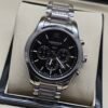 Longines — cronógrafo con esfera negra y brazalete de acero