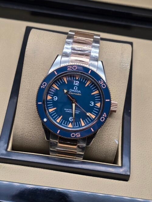 Omega — esfera azul con detalles naranjas, bisel azul y brazalete bicolor